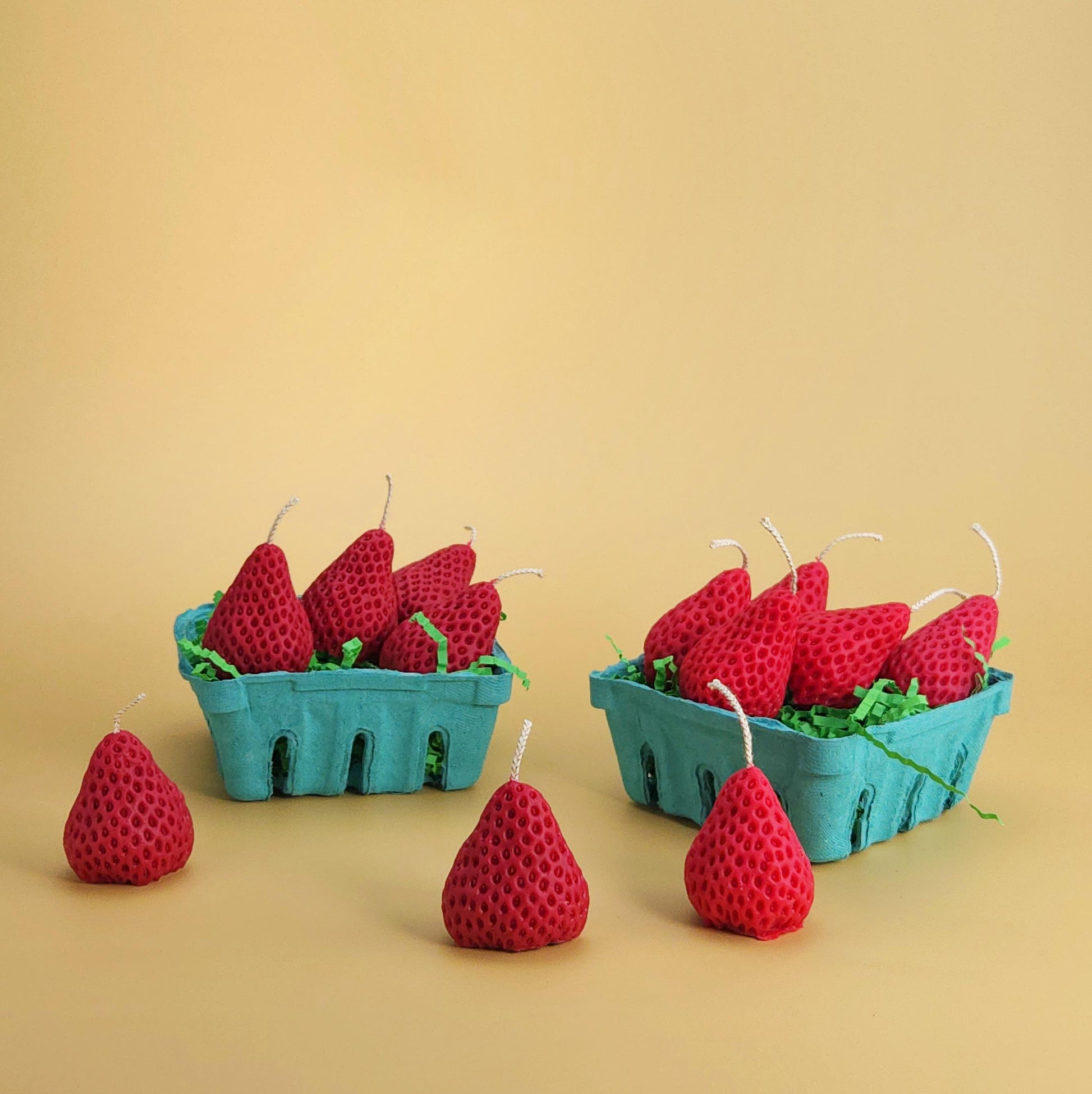 two realistic basket of strawberry candles, strawberry set candle, blue pulp basket of strawberries, red strawberry with wick on yellow background, green crinkle cut paper inside, gift of cake topper, birthday strawberry topper, berry with holes, looks like real strawberry, birthday candles, home decor, kitchen decor candles, giving off a sweet strawberry scent, juicy strawberry, strawberry-shaped soy candles