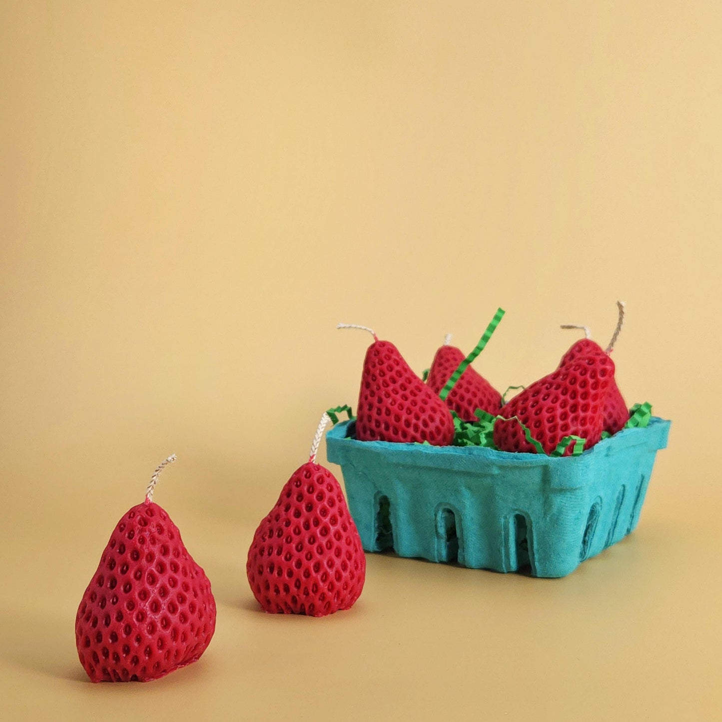 realistic basket of strawberry candles, strawberry set candle, blue pulp basket of strawberries, red strawberry with wick on yellow background, green crinkle cut paper inside, gift of cake topper, birthday strawberry topper, berry with holes, looks like real strawberry, birthday candles, home decor, kitchen decor candles, giving off a sweet strawberry scent, juicy strawberry, strawberry-shaped soy candles