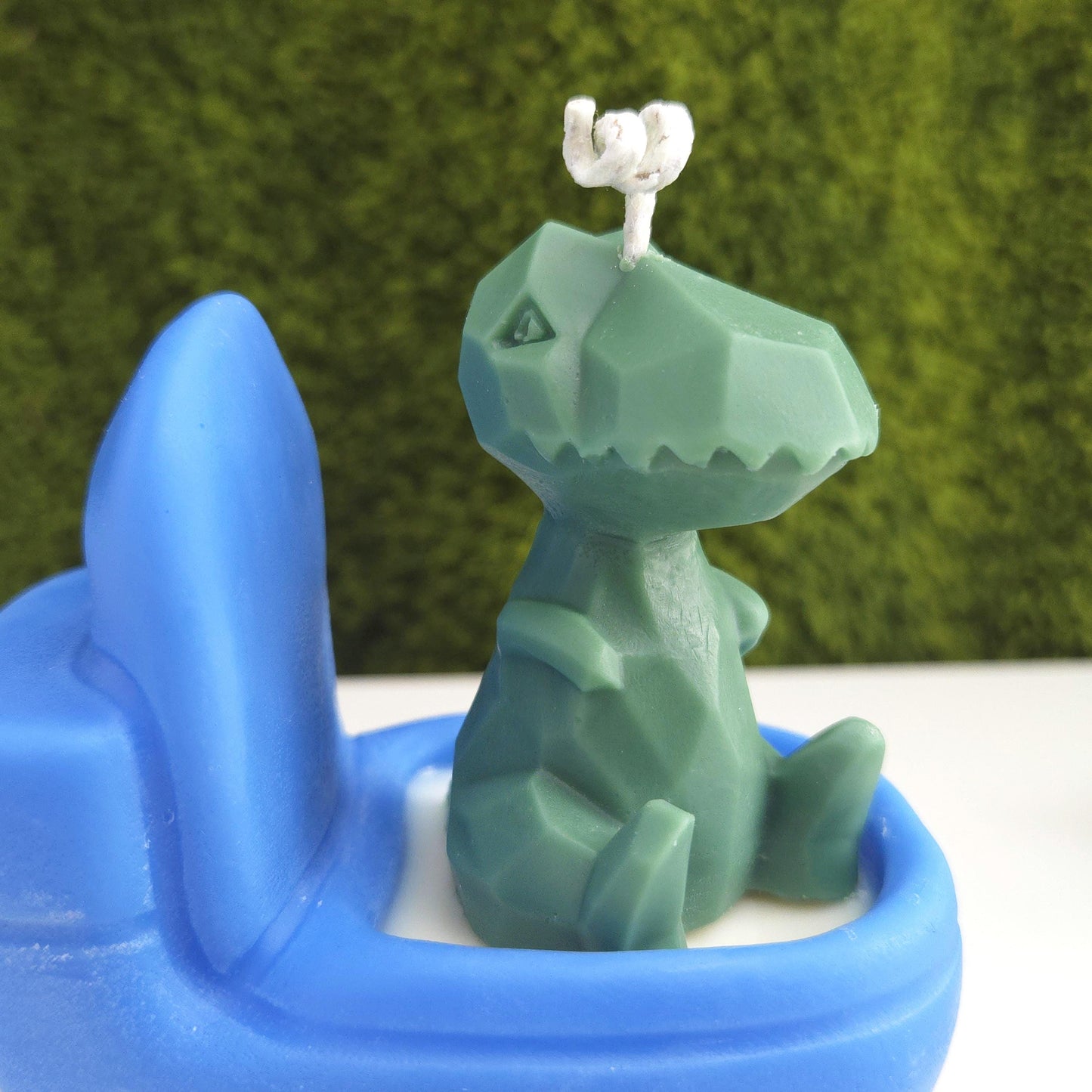 Handmade soy wax candle shaped like a green dinosaur sitting on a blue toilet, funny novelty gag gift