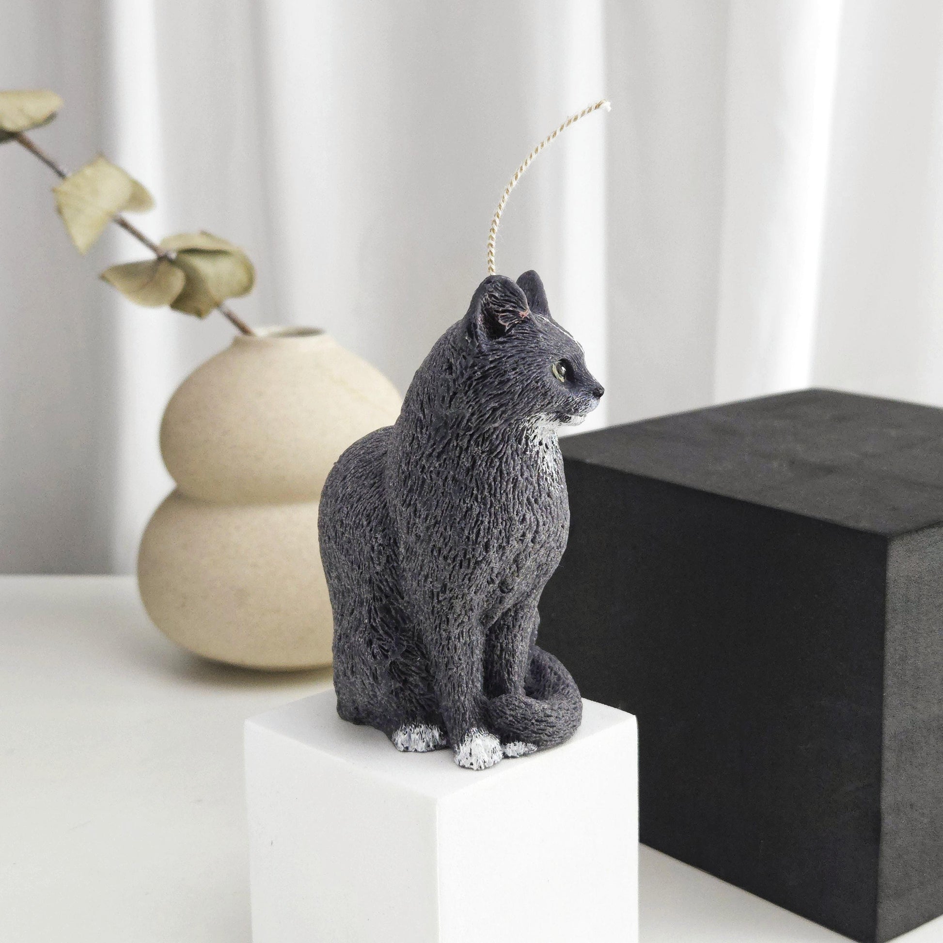Side view of a black cat candle showing detailed fur texture and sculpted cat shape