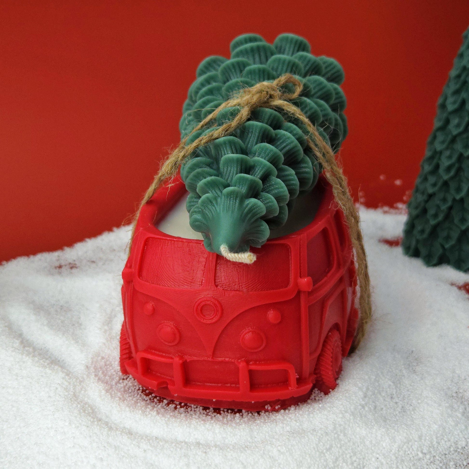 Red vintage car candle carrying a green Christmas tree candle, handmade soy wax holiday decoration.