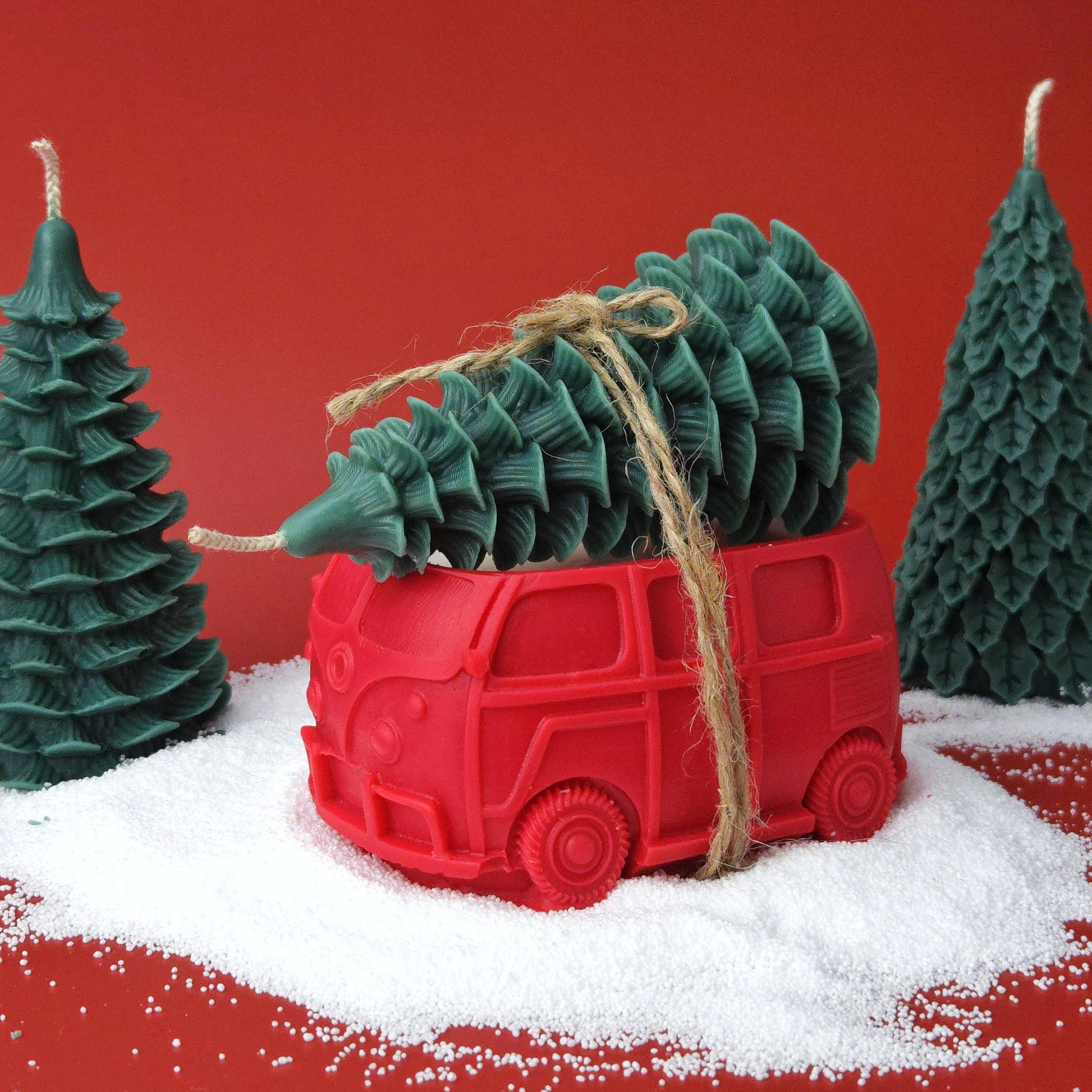 Red vintage car candle carrying a green Christmas tree candle, handmade soy wax holiday decoration.
