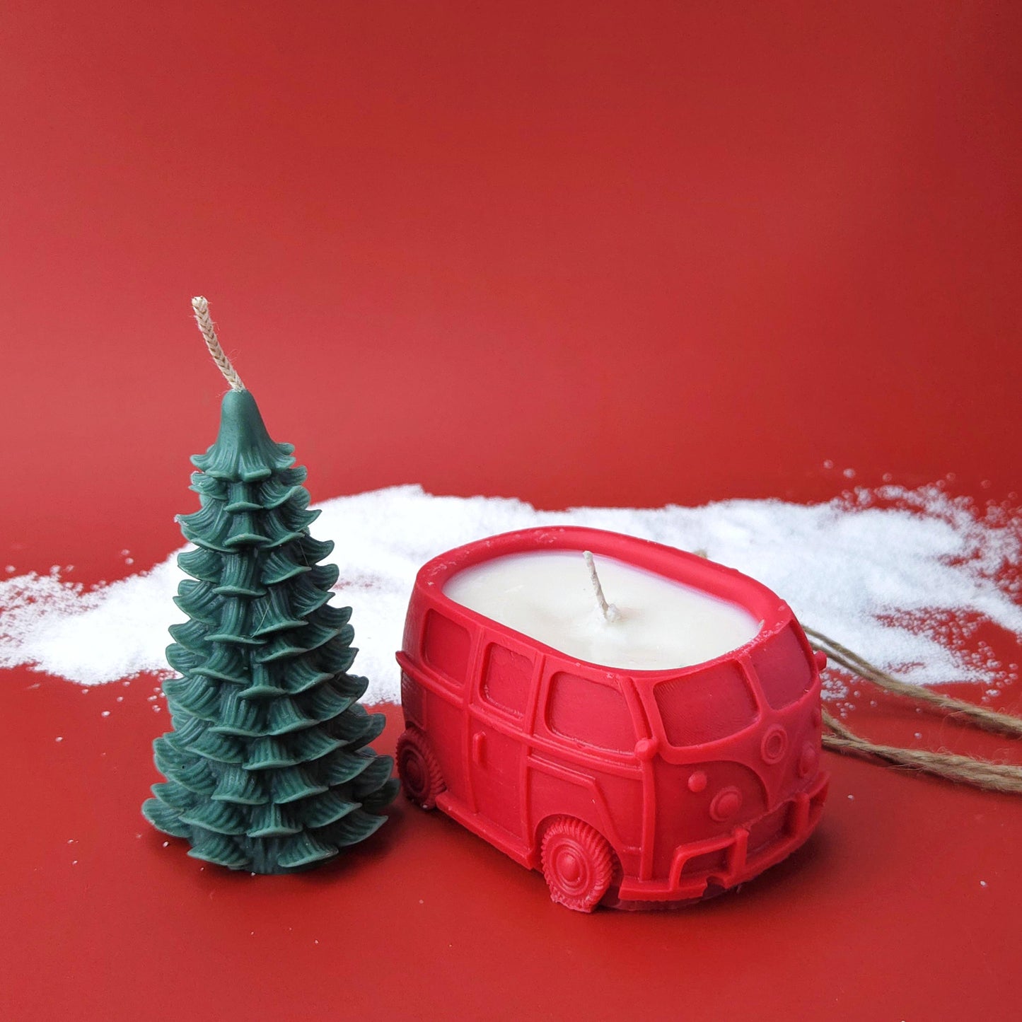 Two-piece Christmas candle set featuring a red car candle and detachable Christmas tree candle tied together with twine.