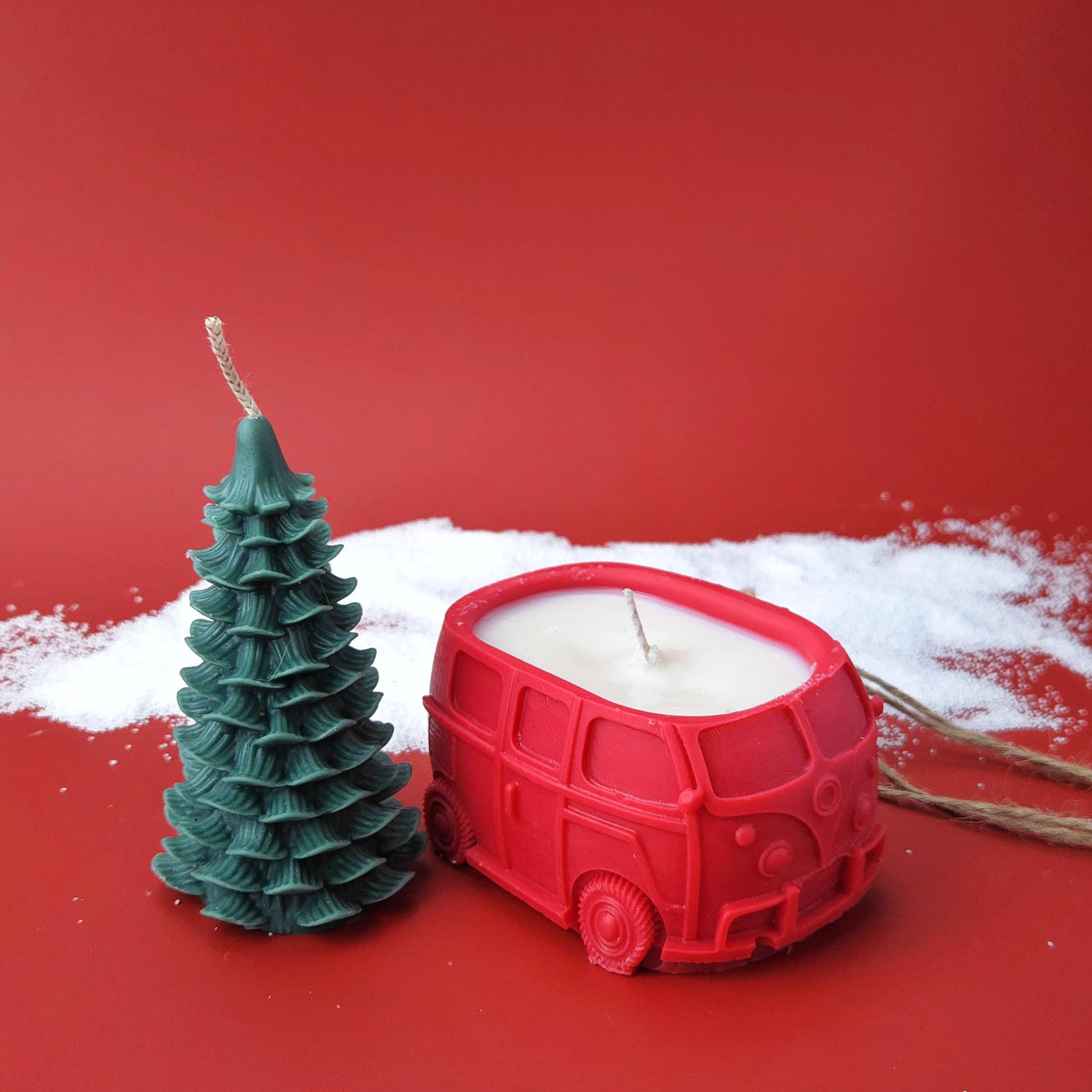 Two-piece Christmas candle set featuring a red car candle and detachable Christmas tree candle tied together with twine.